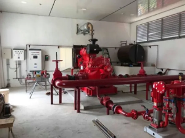 Fire pump room with red pumps, valves and piping