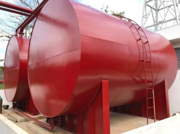 Large red horizontal water storage tank with access ladder