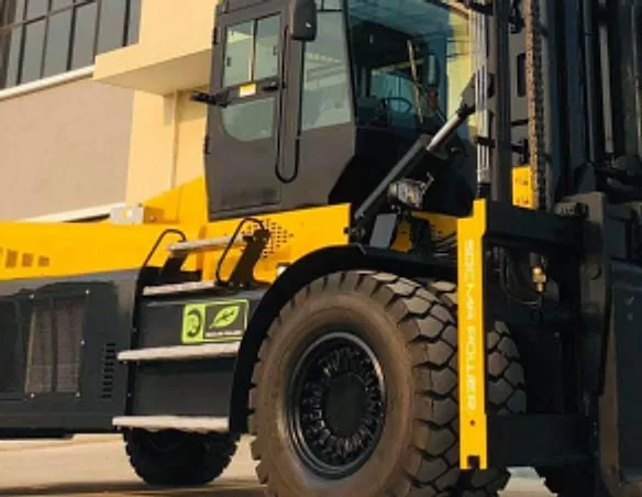 Large yellow and black heavy-duty forklift parked outside a building